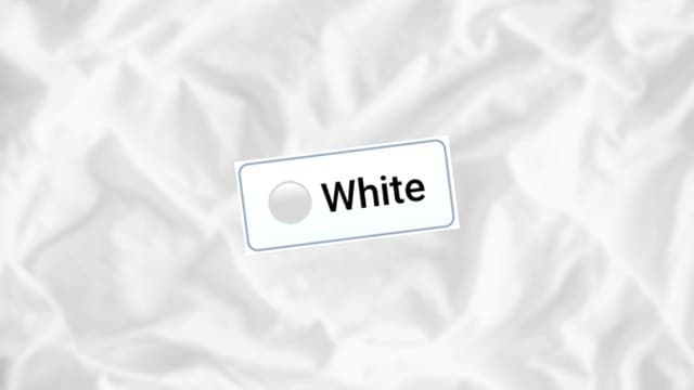 Infinite Craft White block atop a blurred backdrop of white-colored wrinkled sheets