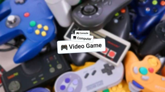 Infinite Craft Video Game, Computer, and Console blocks atop blurred image featuring colorful retro gaming controllers