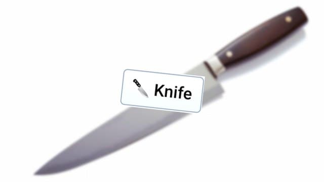 Infinite Craft Knife block atop a blurred image of a kitchen knife